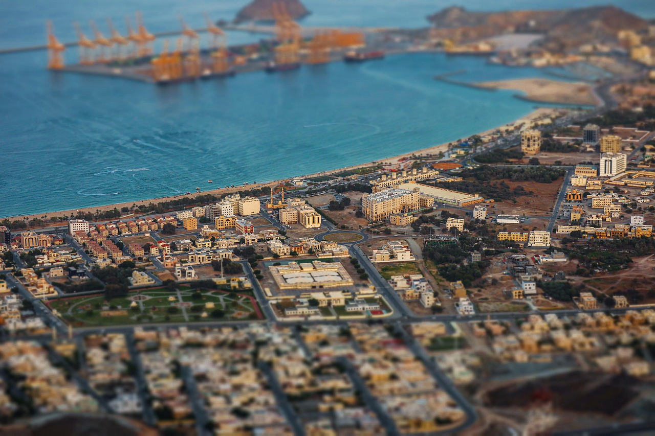 An aerial view of a coastal city and its harbor with a selective-focus effect