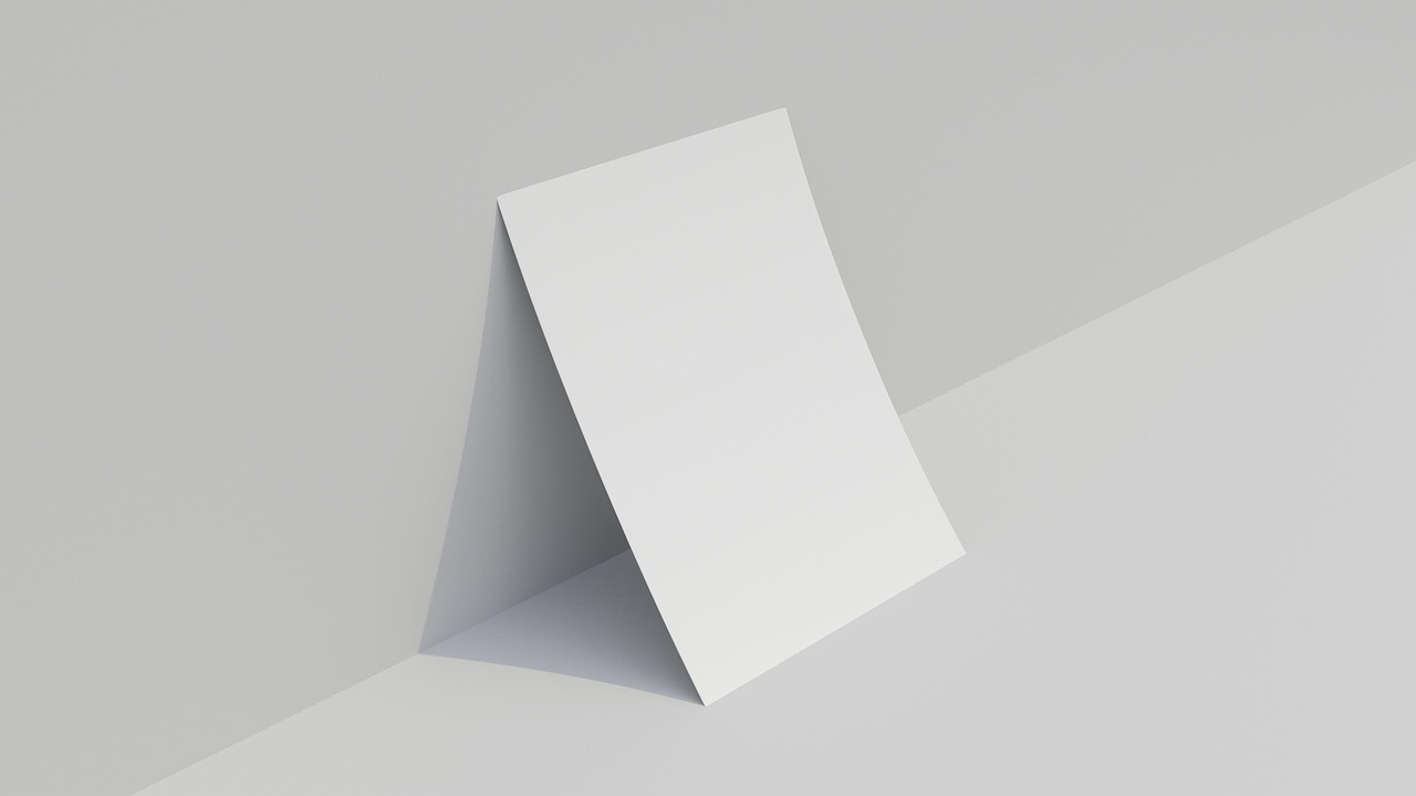 Blank folded paper standing on a light studio surface