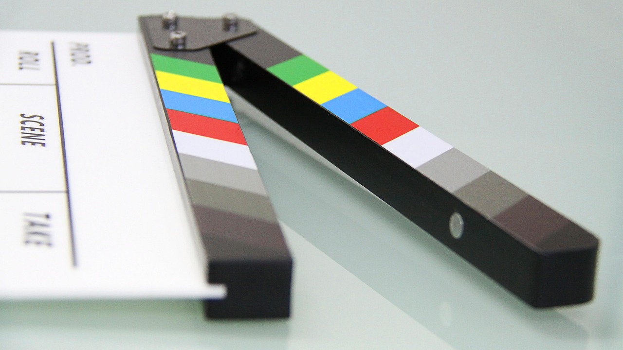 Close-up of a colorful film clapperboard on a studio surface